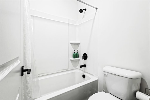 bathroom featuring bathtub / shower combination and toilet