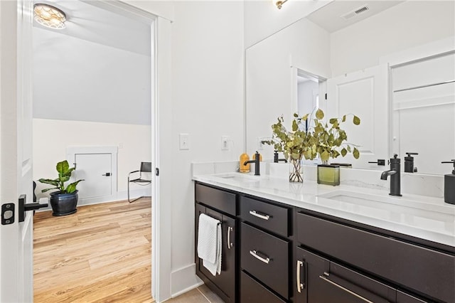 bathroom featuring hardwood / wood-style flooring and vanity