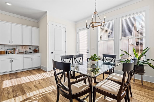 dining room featuring a notable chandelier, light hardwood / wood-style floors, and plenty of natural light