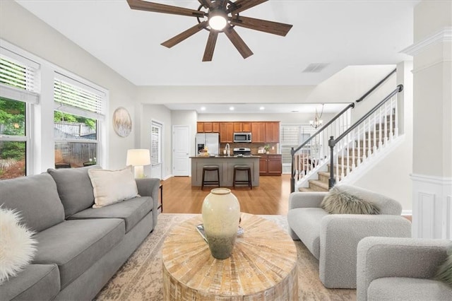 3607 Archgate Ct, Alpharetta, GA 30004 - living area featuring light wood-style floors, stairway, ceiling fan, a chandelier, and recessed lighting