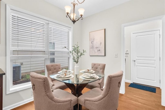3607 Archgate Ct, Alpharetta, GA 30004 - dining room with light wood-style floors, a chandelier, and baseboards