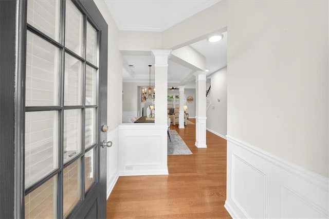 3607 Archgate Ct, Alpharetta, GA 30004 - entrance foyer with ornate columns, crown molding, light wood-type flooring, wainscoting, and a chandelier