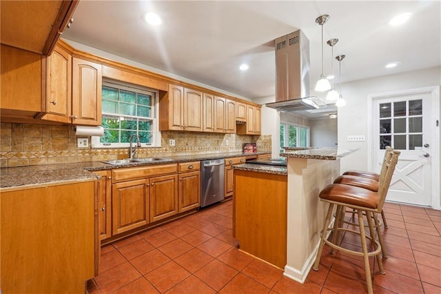 kitchen featuring sink, stainless steel dishwasher, island exhaust hood, pendant lighting, and a kitchen island