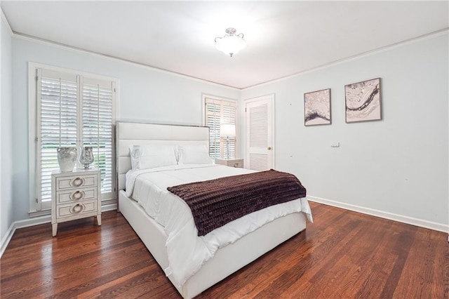 bedroom with dark hardwood / wood-style floors and ornamental molding