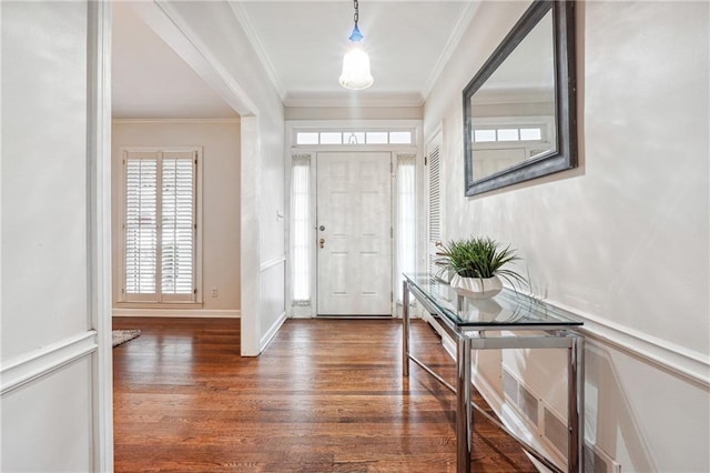 foyer with dark hardwood / wood-style flooring and crown molding