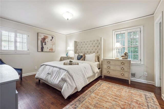 bedroom with dark hardwood / wood-style floors and ornamental molding