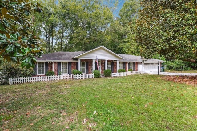 single story home featuring a front lawn and a garage