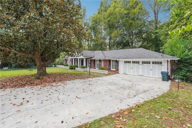 ranch-style home with a garage and a front lawn