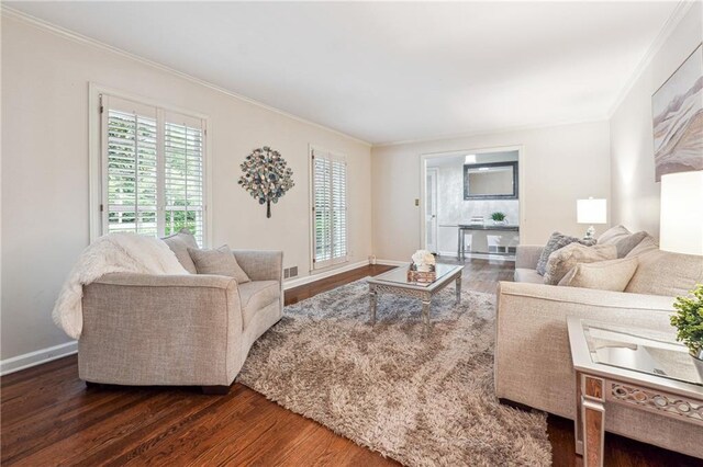 living room with dark hardwood / wood-style floors and crown molding