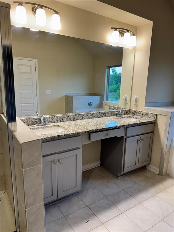 7703 Hansel Ln, Lithonia, GA 30058 - bathroom with double vanity and tile patterned flooring
