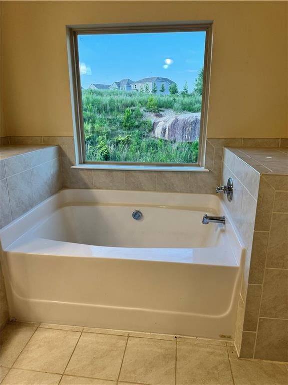 7703 Hansel Ln, Lithonia, GA 30058 - full bath featuring plenty of natural light, a garden tub, and tile patterned flooring