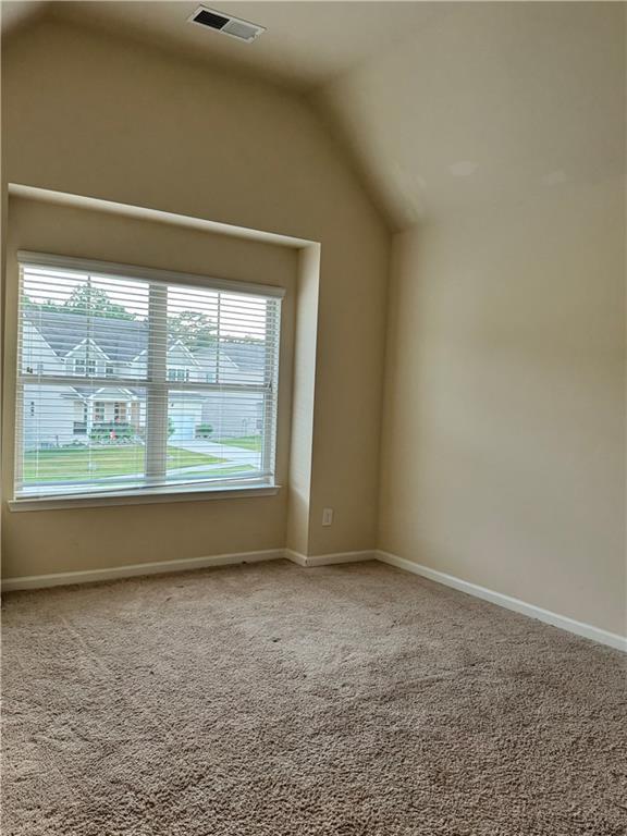 7703 Hansel Ln, Lithonia, GA 30058 - additional living space featuring vaulted ceiling and carpet flooring