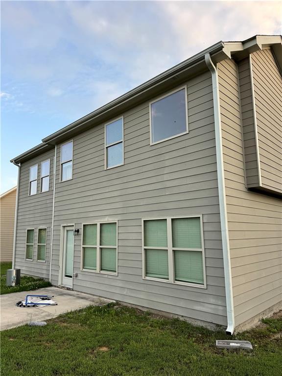 7703 Hansel Ln, Lithonia, GA 30058 - rear view of house featuring a patio and a lawn