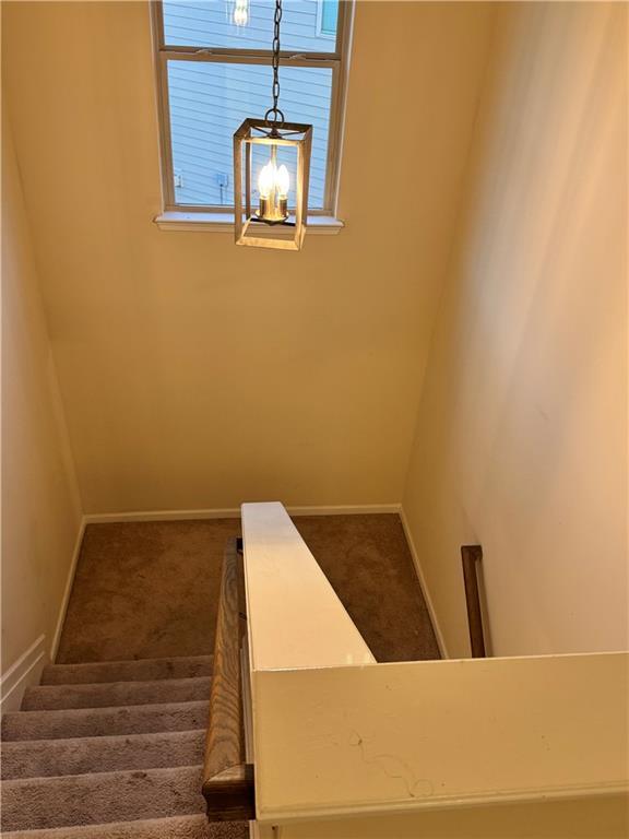 7703 Hansel Ln, Lithonia, GA 30058 - stairway featuring carpet flooring and plenty of natural light