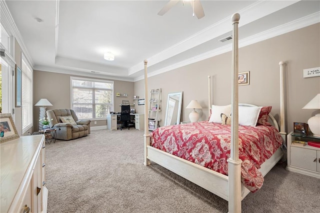 bedroom featuring a raised ceiling, ceiling fan, carpet floors, and ornamental molding