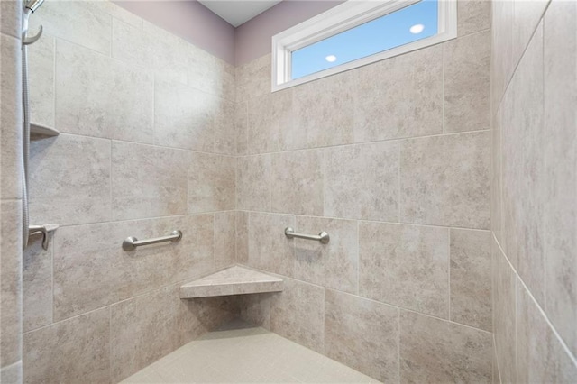 bathroom with a tile shower