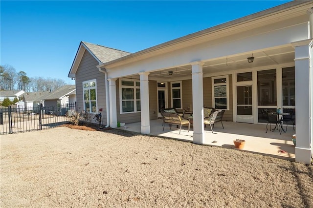 back of property with a patio area and an outdoor living space