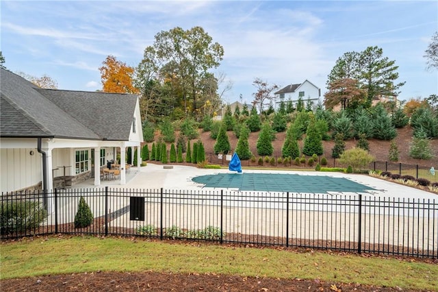 view of pool featuring a patio area and a yard