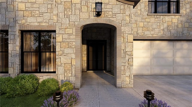 view of exterior entry with a garage