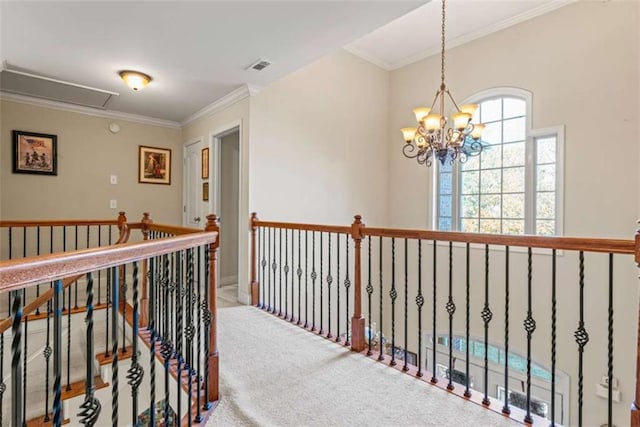 hallway with carpet floors, ornamental molding, and an inviting chandelier