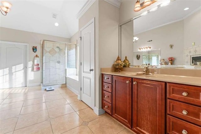 bathroom with vanity, crown molding, tile patterned flooring, an enclosed shower, and a tiled fireplace