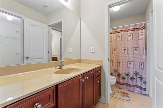 bathroom with tile patterned floors, vanity, toilet, and a shower with shower curtain