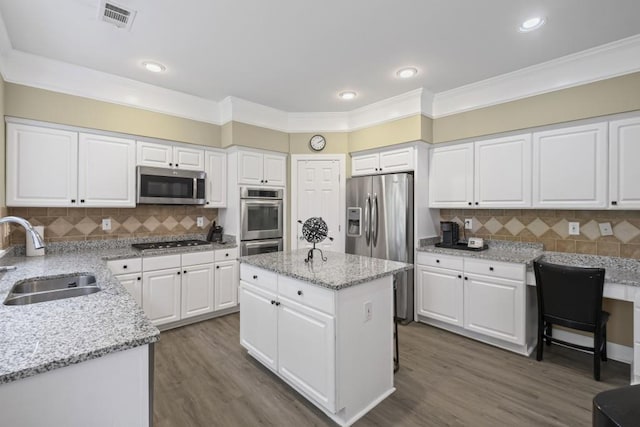 1465 Laleiah Dr, Cumming, GA 30041 - kitchen with visible vents, ornamental molding, a sink, appliances with stainless steel finishes, and backsplash