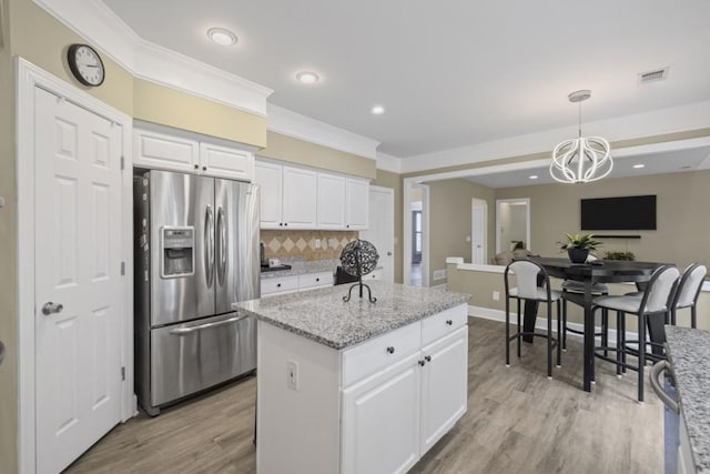 1465 Laleiah Dr, Cumming, GA 30041 - kitchen with decorative backsplash, stainless steel refrigerator with ice dispenser, white cabinets, light wood finished floors, and a notable chandelier