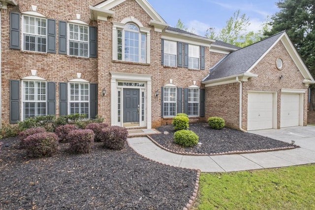 1465 Laleiah Dr, Cumming, GA 30041 - colonial house with brick siding, a garage, and driveway