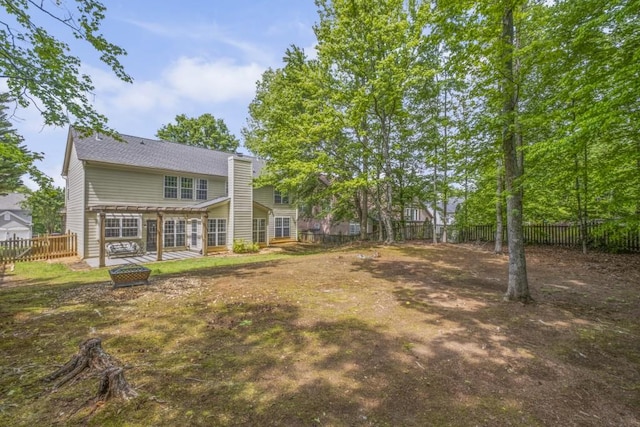 1465 Laleiah Dr, Cumming, GA 30041 - rear view of property featuring a fenced backyard, a wooden deck, and a chimney