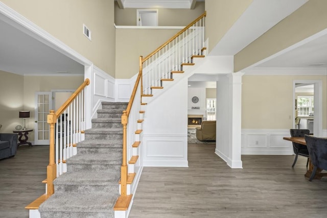 1465 Laleiah Dr, Cumming, GA 30041 - stairs featuring crown molding, visible vents, a healthy amount of sunlight, and wood finished floors