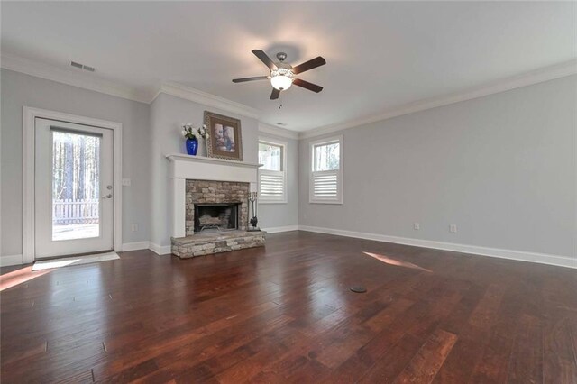 unfurnished living room featuring crown molding, a stone fireplace, ceiling fan, and dark hardwood / wood-style flooring