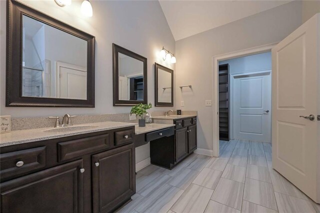 bathroom featuring vanity and vaulted ceiling