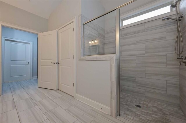 bathroom featuring a shower with door