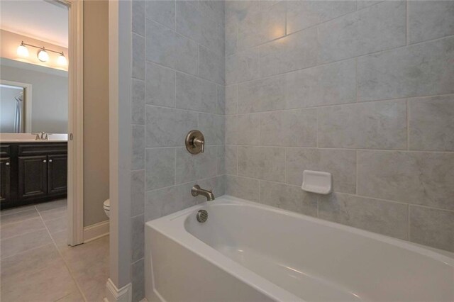 full bathroom with vanity, bathing tub / shower combination, tile patterned floors, and toilet