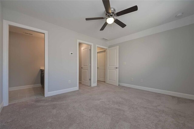 unfurnished bedroom with ceiling fan and light carpet