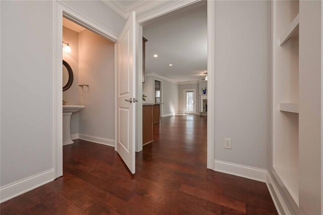 hallway featuring crown molding and dark hardwood / wood-style flooring