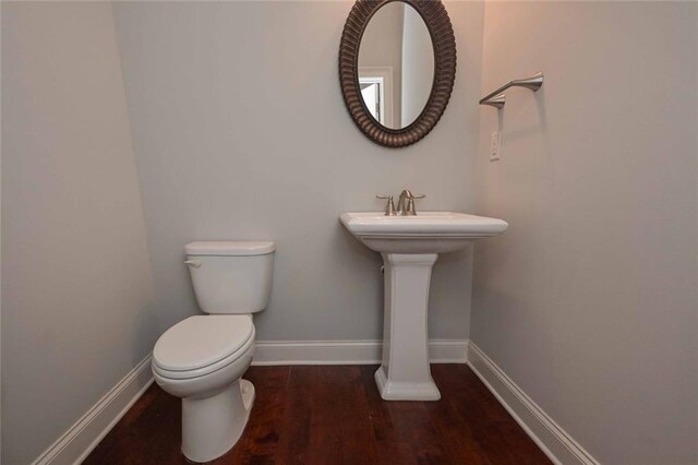 bathroom featuring sink, hardwood / wood-style flooring, and toilet