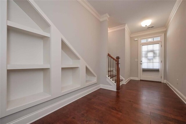 entryway with crown molding and dark hardwood / wood-style floors