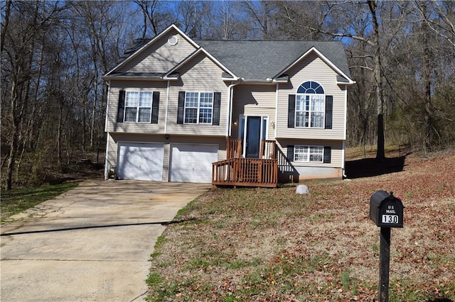 bi-level home with concrete driveway and an attached garage