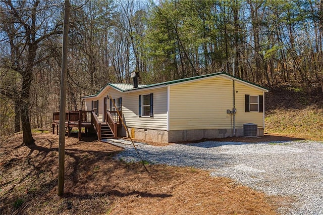 view of side of home featuring a deck, metal roof, and crawl space