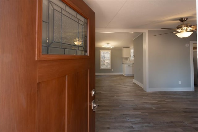 foyer with ceiling fan, baseboards, and dark wood finished floors