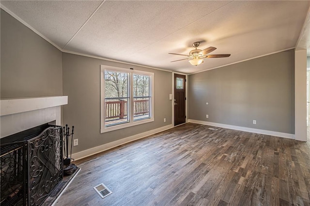 unfurnished living room featuring visible vents, a fireplace, ornamental molding, dark wood-type flooring, and a textured ceiling