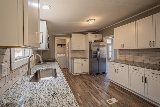 kitchen with visible vents, stainless steel fridge with ice dispenser, dark wood-style flooring, white cabinets, and a sink