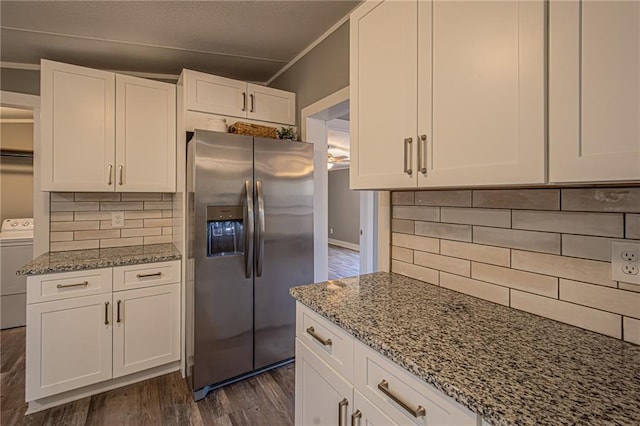 kitchen featuring washer / dryer, white cabinetry, stainless steel refrigerator with ice dispenser, and light stone countertops