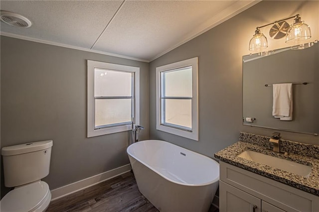 bathroom featuring visible vents, vanity, vaulted ceiling, wood finished floors, and a textured ceiling