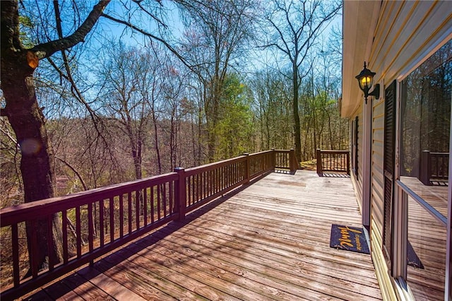 wooden terrace with a wooded view