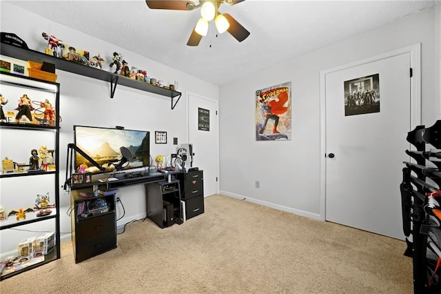 carpeted home office featuring baseboards, a ceiling fan, and a textured ceiling