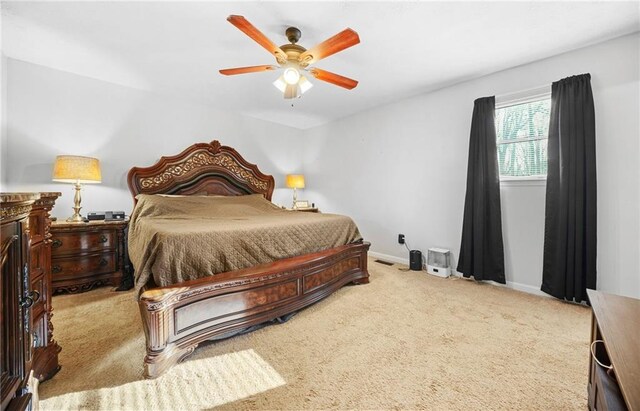 carpeted bedroom featuring ceiling fan and baseboards