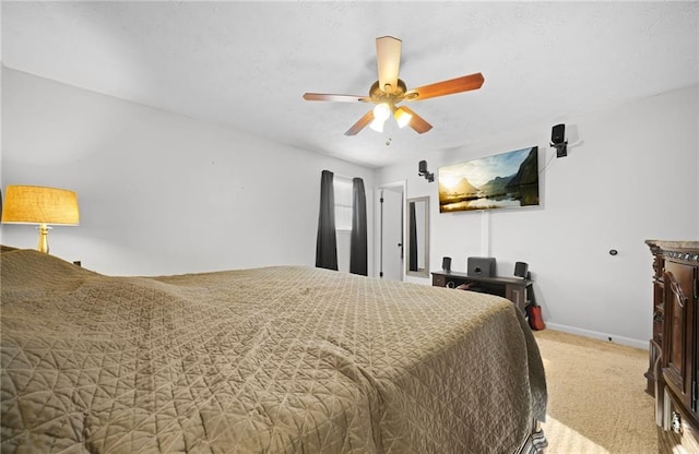 bedroom with a ceiling fan, carpet, and baseboards